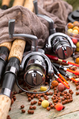Obraz premium fishing tackle on a wooden table. toned image 