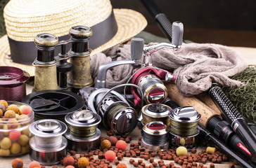 fishing tackle on a wooden table. toned image 