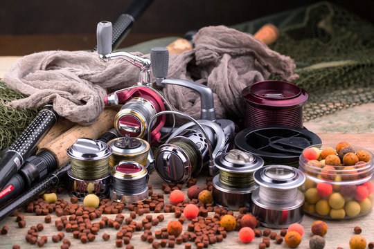 fishing tackle on a wooden table. toned image 