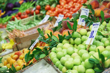 Bright fresh vegetables and fruits on the counter of the street night market. 