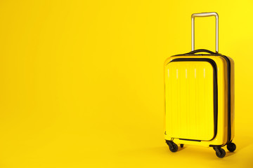 Stylish suitcase on color background. Space for text