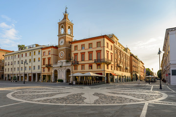 Fototapeta na wymiar Central square of Rimini, Italy. Three Martyrs square with an ancient clock tower.