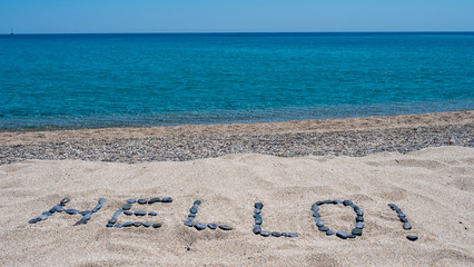 Hello written in sand on mediterranean beach