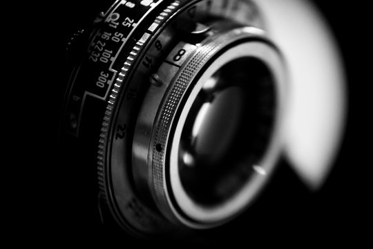 old camera lens on black background