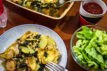 Simply, fast and tasty vegetarian food with potato and spinach in plate with salad
