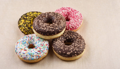 Sprinkled confetti with baked donuts with different icing. Wrapping paper