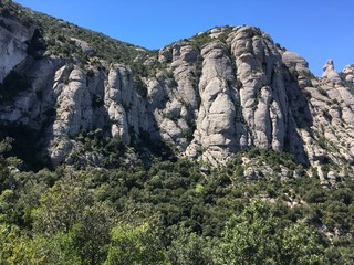 Fototapeta na wymiar Montserrat serrated mountains in Spain, surrounded by greenery
