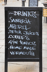 Blackboard menu with several drinks placed on the street outside a restaurant in Barcelona, Spain