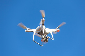 Flying drone with blue sky background, technology