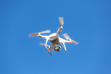 Flying drone with blue sky background, technology