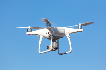 Flying drone with blue sky background, technology