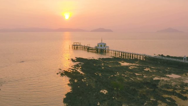 aerial view sunrise at pier of Phayam temple one landmark of Phayam island. Phayam temple is on Hin Kao gulf. .The temple is close to the shipping port. in the end of Phayam temple pier have memorial
