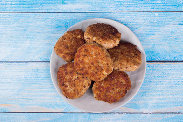 cutlets on a grey plate, on a blue wooden background
