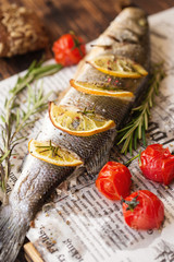 Oven-baked Sea bass with lemon and herbs. fish, baked entirely