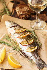 Oven-baked Sea bass with lemon and herbs. fish, baked entirely