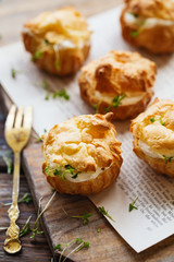 Spicy profiteroles with cream cheese decorated with cress salad