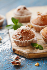 Sweet muffins. Homemade bakery on wooden background. Berry muffins