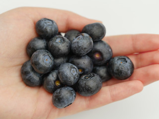 Holding large blueberries in hand