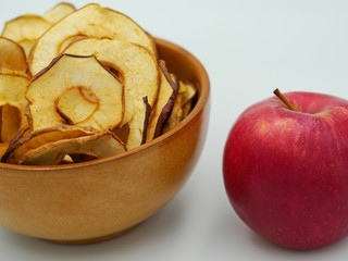 Apple chips positioned near a red apple