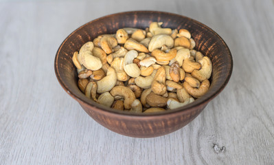 Healthy food  for background image close up cashew nuts.  Nuts texture on white grey table top view on the cup plate