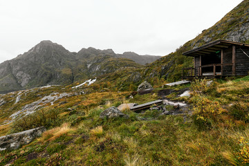 Fototapeta na wymiar Wooden cabin in the mountains on Lofoten Islands in Norway at the coast