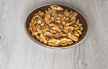 Healthy food  for background image close up walnuts.  Nuts  texture on white grey table top view on the cup plate