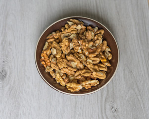 Healthy food  for background image close up walnuts.  Nuts  texture on white grey table top view on the cup plate
