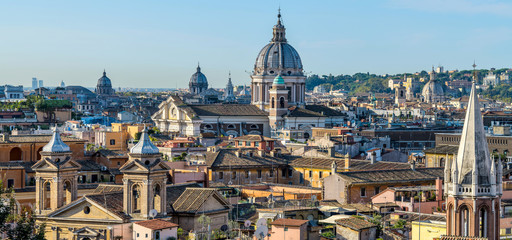 Good Morning Rome - A panoramic view of north skyline of the historical centre of Rome, with the dome of 17th-century Basilica of San Carlo al Corso towering at center, on a sunny October morning.