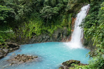 scenic waterfall in tenorio volcano national park - obrazy, fototapety, plakaty