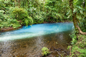 scenic Rio Celeste in the rain
