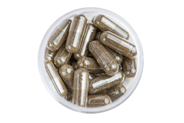 Medicine brown pills in the white bottle on white background.