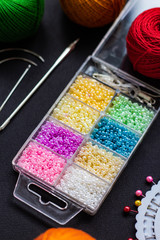 multi-colored beads and other elements of needlework (beadwork): yarn, needle