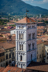 Fototapeta na wymiar View on old city with Basilica of San Michele from Torre delle Ore clock tower in Lucca. Italy