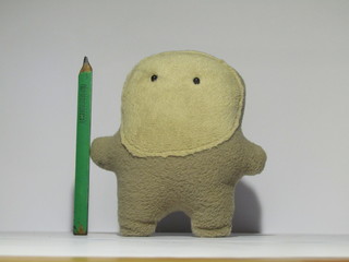 plush toy with pensil on white blank background