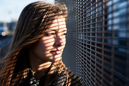 Portrait of young woman with shades on her face looking at distance