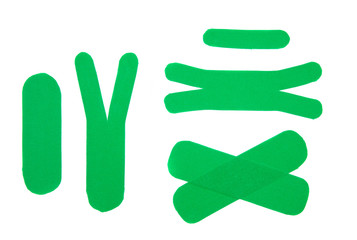 Set of diffrent shape and size green sport elastic kinesio therapeutic tape, also called kinesiology tape strips isolated on white background. Flat lay top view.