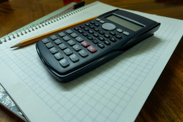 Calculator, notebook and pen.
