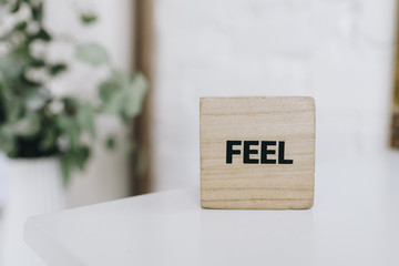 Wooden cubes or dice with a message saying "Feel".