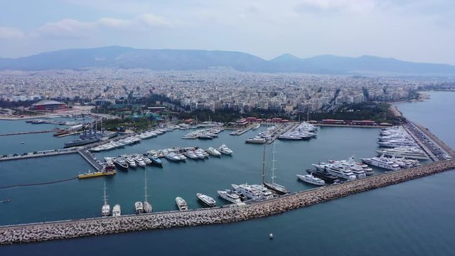 Aerial drone video of famous Flisvos Marina with mega yachts and sail boats docked, Athens riviera, Attica, Greece