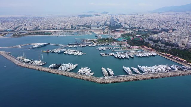 Aerial drone video of famous Flisvos Marina with mega yachts and sail boats docked, Athens riviera, Attica, Greece