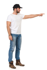 Handsome Man In Jeans, T-Shirt, Boots And Black Cap Is Directing
