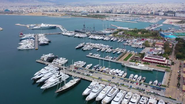 Aerial drone video of famous Flisvos Marina with mega yachts and sail boats docked, Athens riviera, Attica, Greece