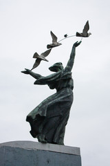 Sculpture of a woman with pigeons at the metro station Dnepr