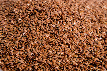 Top view. The surface of the heap of flaxseeds. Background. Close up, macro.