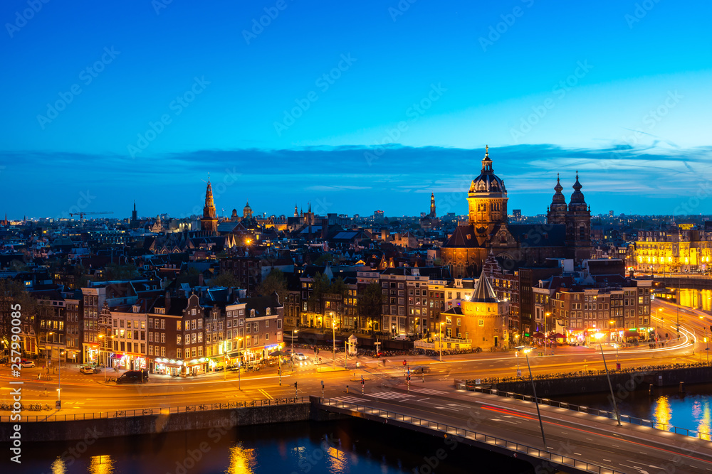 Wall mural aerial view of amsterdam skyline in historical area at night in amsterdam, netherlands.