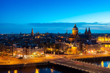 Aerial view of Amsterdam skyline in historical area at night in Amsterdam, Netherlands.