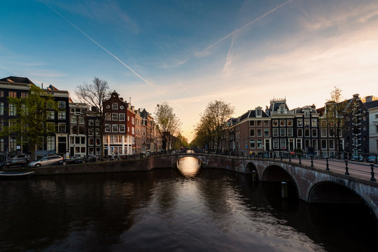 City view of Amsterdam, the Netherlands with Amstel river during sunset.
