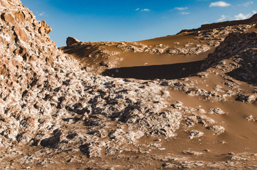 Rocky dunes and dark brown sand in Atacama desert. Chile