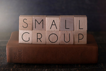 Small Group Spelled in Block Letters on a Table with a Bible