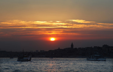 Naklejka premium During the sunset historical peninsula and Galata Tower in Istanbul, Turkey. This picture was taken from the Kadikoy District.